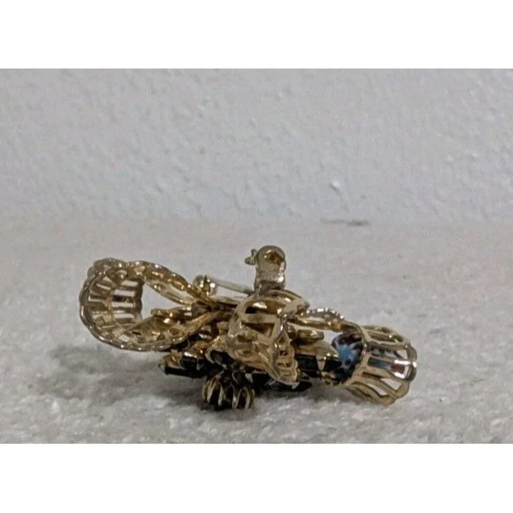 Purple Rhinestone Gold Tone Floral Brooch Signed KRAMER OF NEW YORK Vintage Pin